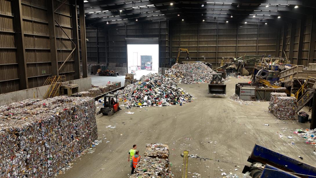 The main floor of James Waste Recycling facility in Rochford. Piles of collected recycling are being placed on conveyer belts and turned into bales of recycled material.